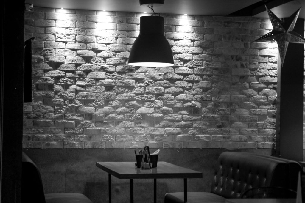 a black and white photo of a brick wall