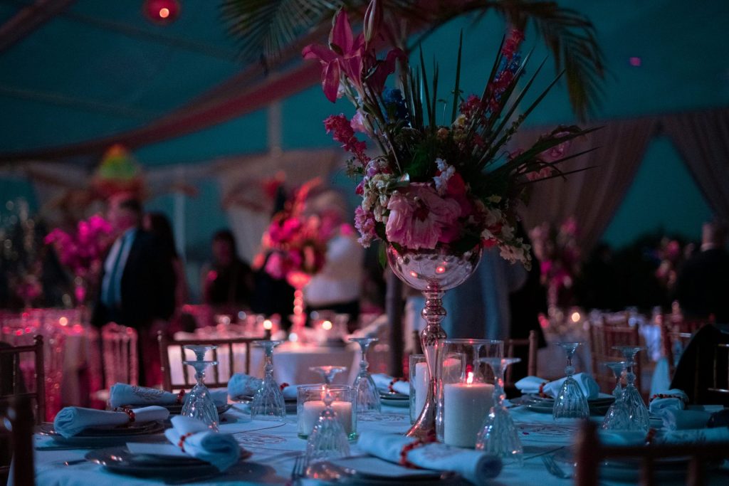 a table with a vase of flowers and candles on it